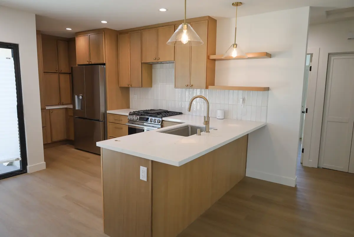 Kitchen with oak cabinets and a white peninsula