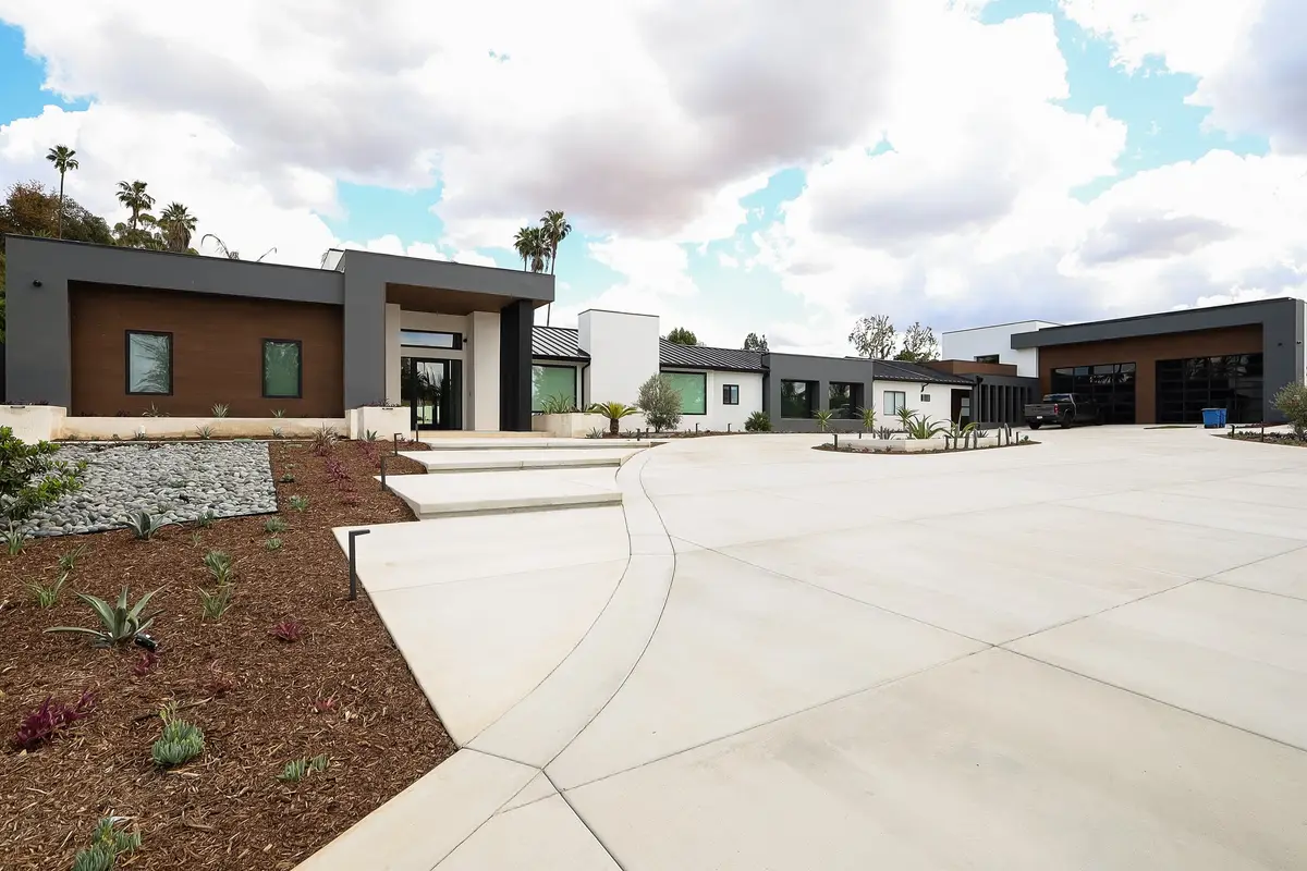 Finished modern custom home with a wide concrete driveway, by J.O. Construction, custom home builder in chino, CA
