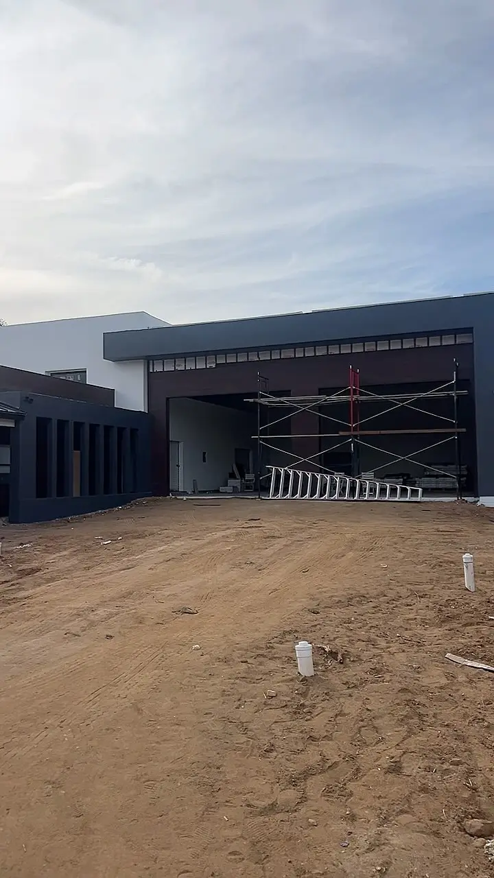 10,308 sq ft modern custom home in Riverside, CA: modern custom home exterior with scaffolding during construction