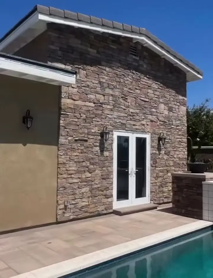 Stone-faced gable and French doors on a pool house ADU