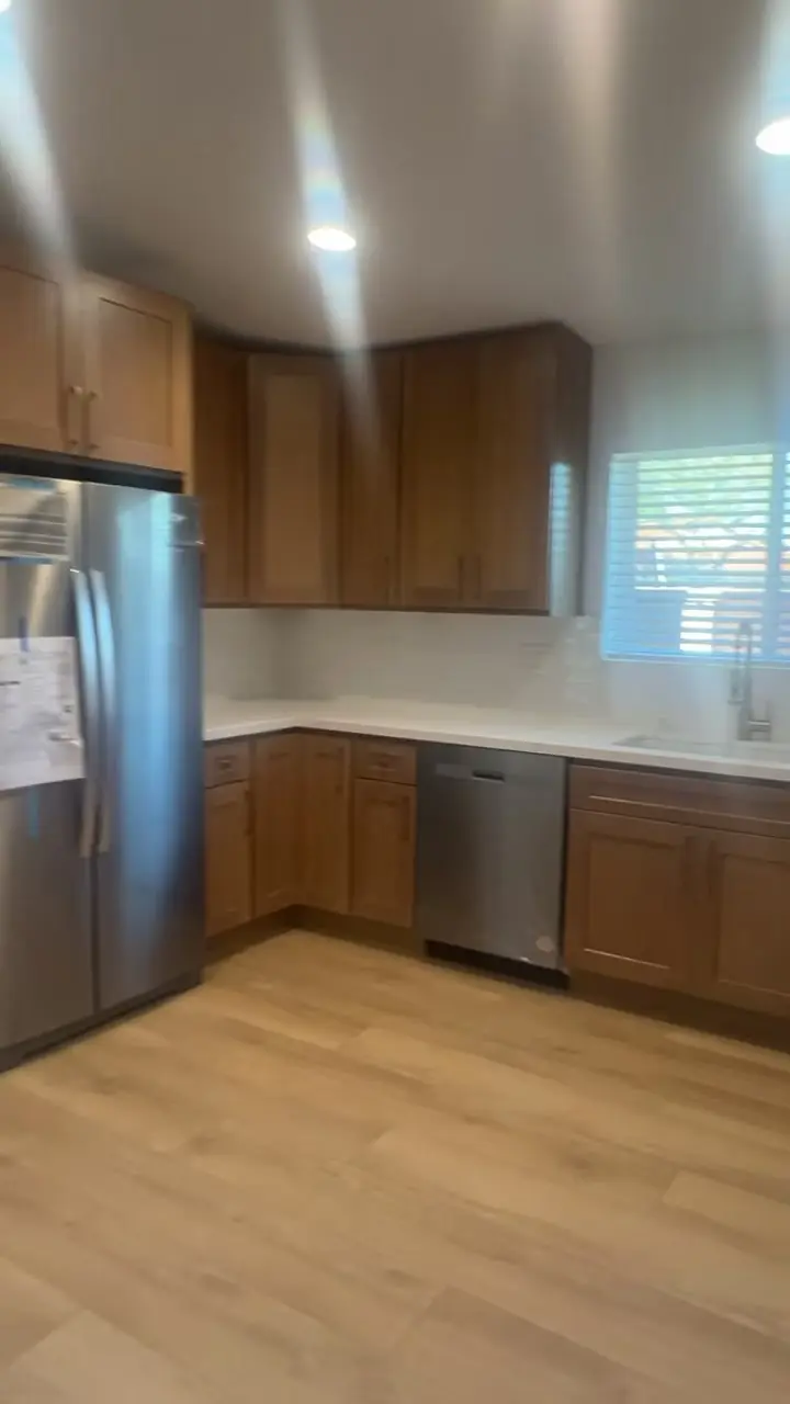 ADU kitchen with white oak cabinets, quartz counters and stainless appliances