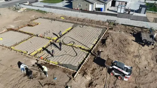 Aerial view of a slab pour with crew working the concrete